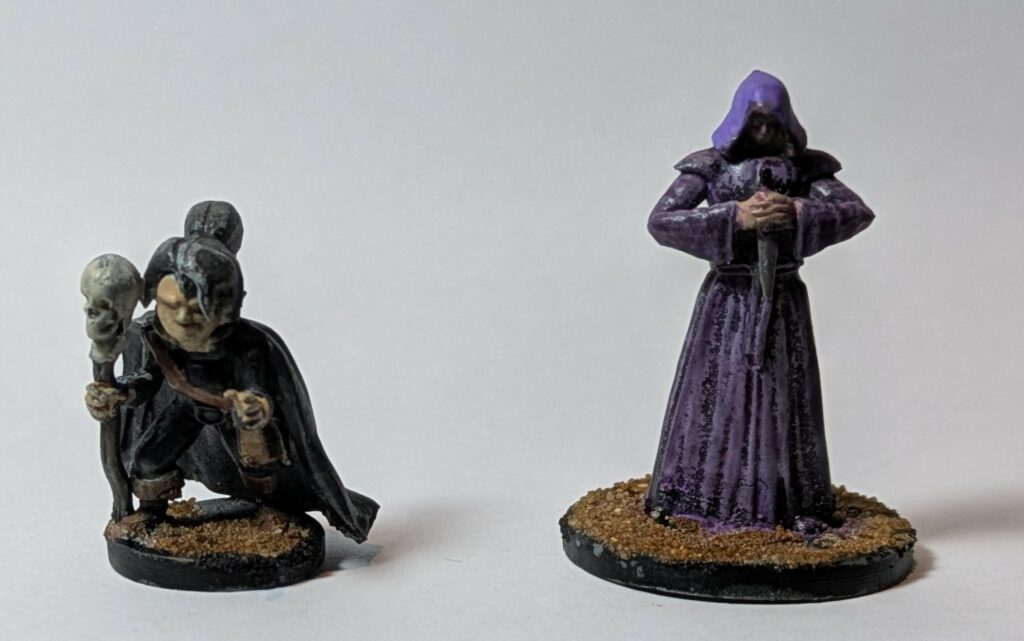 A black gnome necromancer and a purple assassin-mage