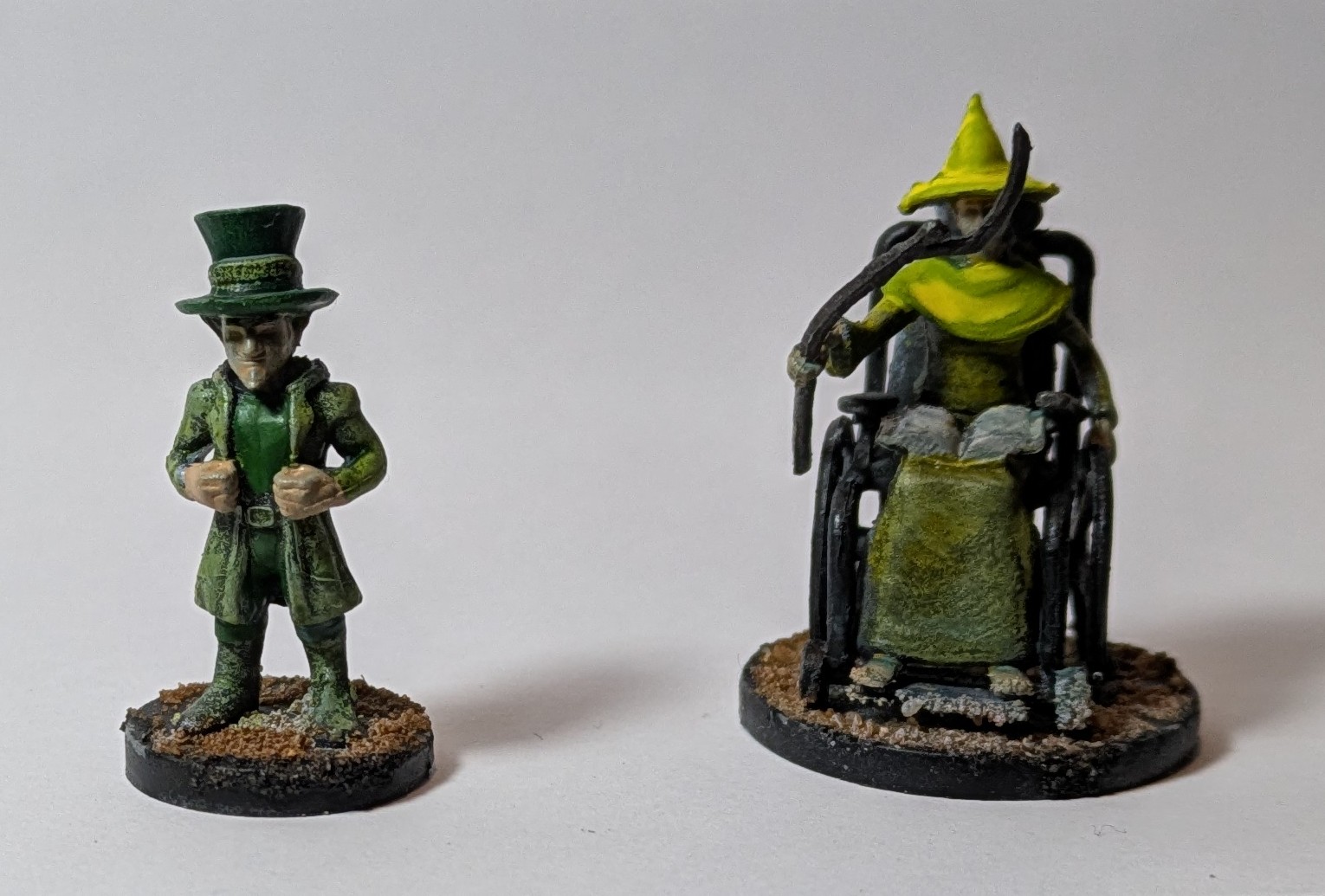 A green leprechaun and a yellow wizard in a wheelchair