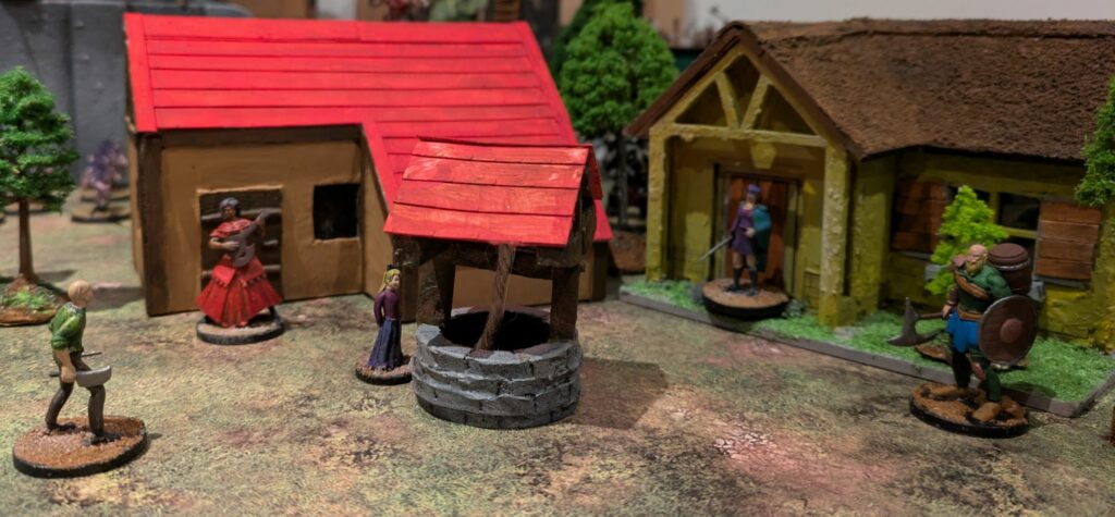 A flamenco lady is playing the guitar in front of a small house, a nobleman with a sword is in front of another house, a warrior with an axe and a shield is watching a menacing man with a butcher cleaver, who is himself watching a small blond girl near a well.