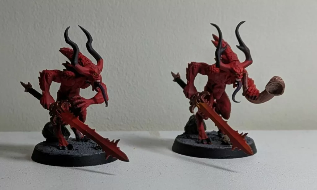 Two Warhammer 40K Khorne Chaos Daemons Bloodletters, one with a hunting horn, the other with just a sword