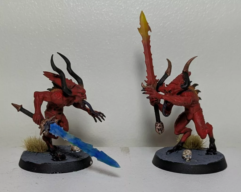 Two Warhammer 40K Khorne Chaos Daemons Bloodletters, one is wielding a blue sword