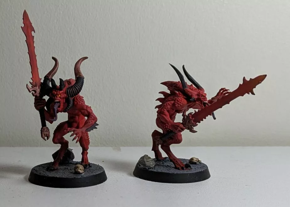 Two Warhammer 40K Khorne Chaos Daemons Bloodletters, both with a sword, one has metalic horns on his head