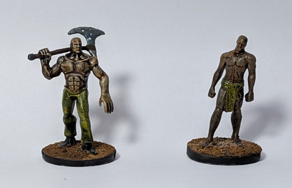 Two buffed half naked warrios, one is bare handed with just a loin cloth, the other is wielding a two hand axe.