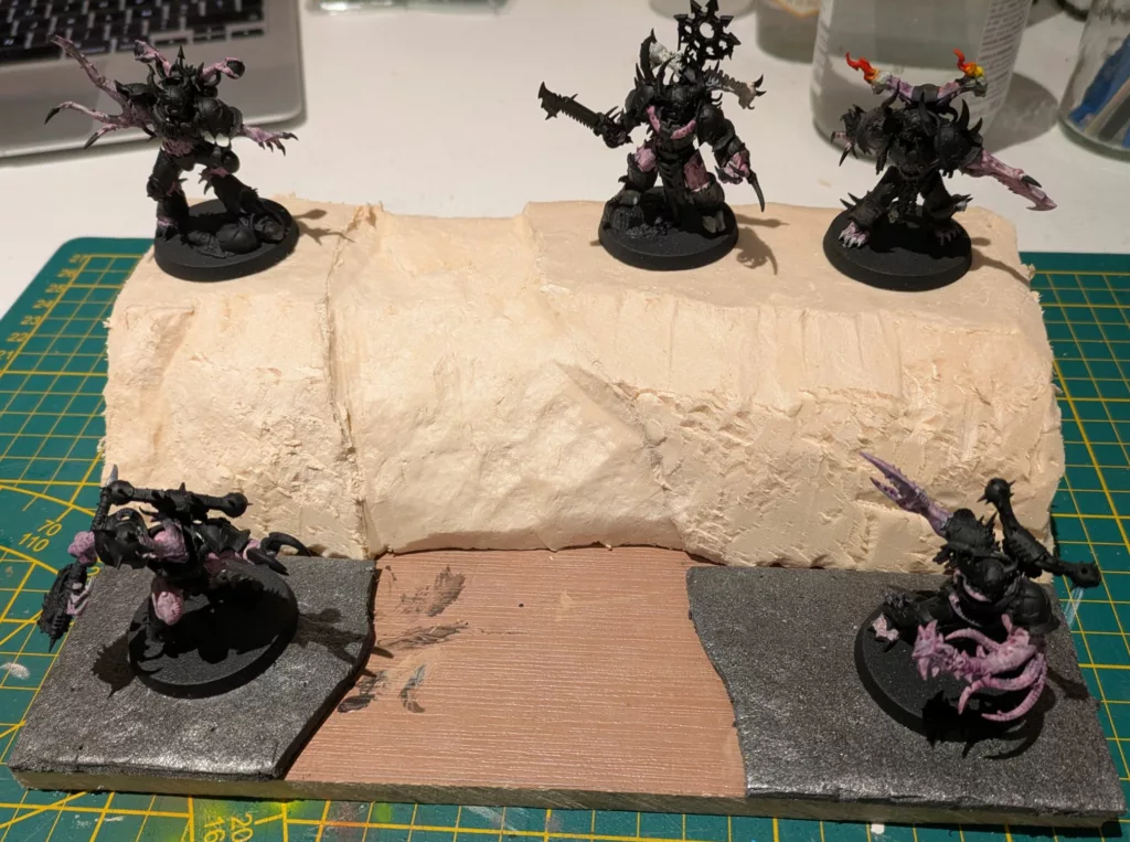 Five Warhammer 40K Black legion Chaos space marines Possessed, unpainted, standing on isolation and XPS foam.