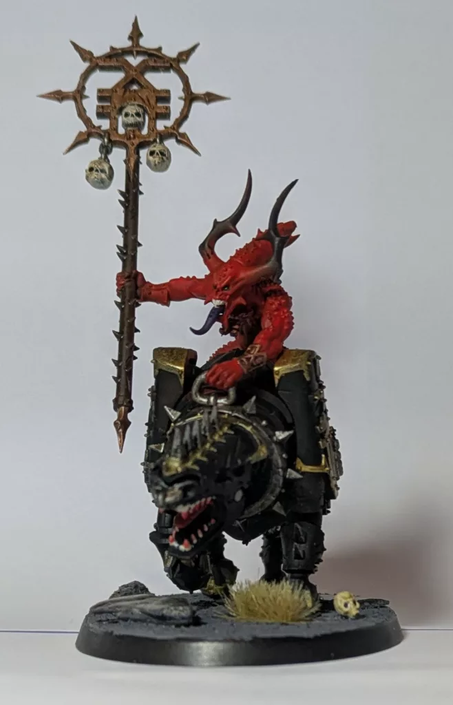 Warhammer 40K Chaos Daemons Bloodcrushers holding a pole with some skulls on it.